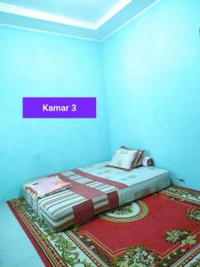Postel nebo postele na pokoji v ubytování Homestay Mutiara Syariah