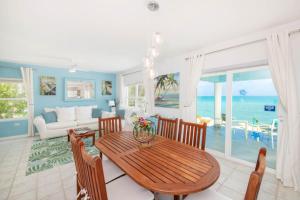 a living room with a table and a view of the ocean at Blue Moon home in Gun Bay
