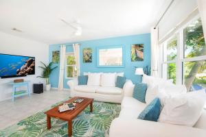 a living room with blue walls and white furniture at Blue Moon home in Gun Bay