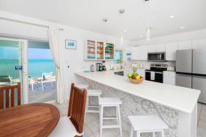 a kitchen with a view of the ocean at Blue Moon home in Gun Bay