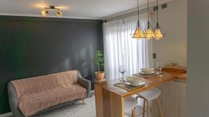 a dining room with a table and a chair at Cabaña 1, Barrio Santa Elena in Valdivia