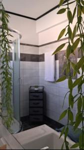 a bathroom with a shower and a sink and a plant at Compass in Kavála +22 photos