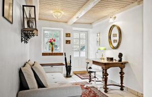 a living room with a table and a piano at Amazing Home In Ulfborg With Kitchen in Ulfborg