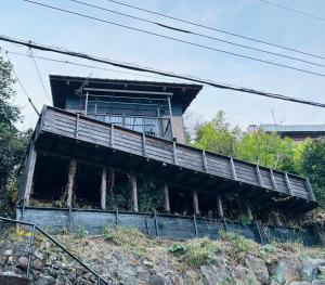 a building on top of a hill at 熱海伊豆の絶景リゾート初島を臨む 開放感溢れるモダンデザインの隠れ家 in Atami