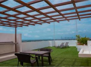 a patio with a table and chairs on a roof at Ph Torres del Este in Salsipuedes