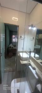a bathroom with a sink and a mirror at Apartamento in Belo Horizonte