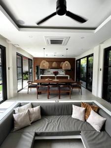 a living room with a couch and a table at Villa Anela in Puerto Princesa City