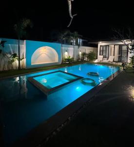 a swimming pool lit up at night at Villa Anela in Puerto Princesa City