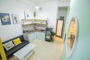 a living room with a kitchen with a counter and a mirror at Promotion Quoc Tu Giam 202 in Hanoi