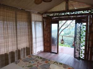 a room with a bed and a sliding glass door at Tukus in Villeta