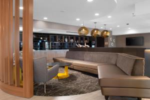 a hotel lobby with a couch and a bar at SpringHill Suites by Marriott Little Rock in Little Rock