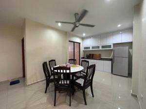 a dining room with a table and chairs in a kitchen at Desa Tebrau 1 Near IKEA Toppen PeiKin Long Sing HeLiXuan Restaurant in Johor Bahru