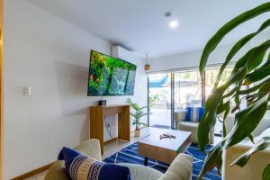 a living room with a tv on a wall at Chapultepec Residence NEW in Guadalajara