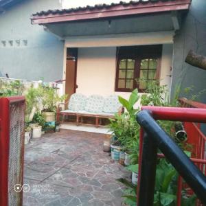 a patio with a bench in a house at PM Room in Jakarta