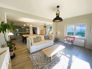 a living room with a couch and a table at Maison 5 chambres à 150 m de la plage, rénovée, jardin, proche restaurants et commerces - FR-1-481-161 in Bénodet +28 photos