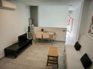 a living room with a table and a couch at Olof Apartment in Las Palmas de Gran Canaria