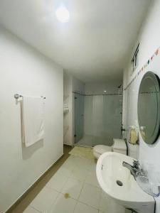 a bathroom with a sink and a toilet and a mirror at Cerca a hotel las americas in Cartagena de Indias