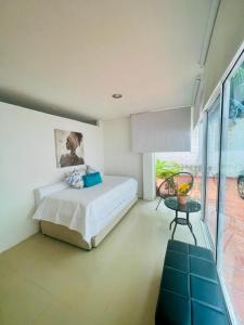 a bedroom with a bed and a large window at Cerca a hotel las americas in Cartagena de Indias