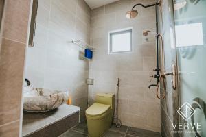 a bathroom with a toilet and a sink and a shower at Ipoh Garden Luxury House By Verve (14pax) in Ipoh +52 photos