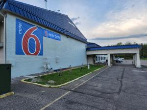 a building with a sign on the side of it at Motel 6 Williamstown, WV in Williamstown