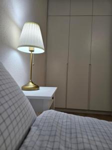 a bedroom with a bed and a lamp on a table at Fully furnished apartment fantastic view city center in Ulaanbaatar