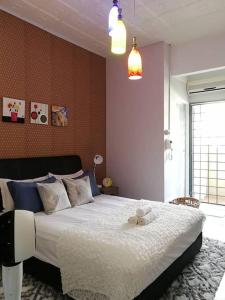 a bedroom with a bed with a teddy bear on it at Cozy home@Friendship Garden 3 in Kota Kinabalu
