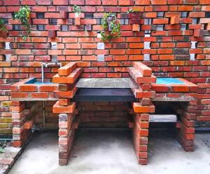 a brick wall with a sink in front of it at Cozy home@Friendship Garden 3 in Kota Kinabalu