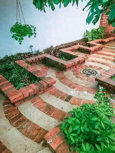 a garden with bricks and plants on a patio at Cozy home@Friendship Garden 3 in Kota Kinabalu