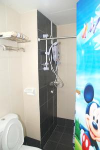 a bathroom with a toilet and a shower stall at Qstay Sitiawan Townhouse (Minnie Dreams) - 米妮梦 in Sitiawan