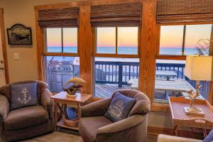 a living room with two chairs and a view of the ocean at 23252 Rodanthe in Nags Head