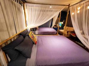 a bedroom with two beds in a tent at Nego Home Ancient Inn in Bangkok