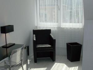 a chair in a room with a table and a window at VISIONAPARTMENTS Freyastrasse - contactless check-in in Zürich