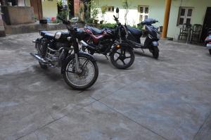 a couple of motorcycles parked next to each other at Vinayaka Deluxe Lodge in Kushālnagar