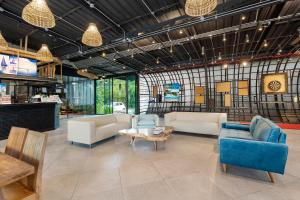 a living room with couches and chairs and a table at Samui Fishing Club and Resort in Na Mueang