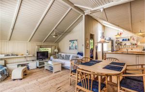 a living room with a table and a couch at Three-Bedroom Holiday Home In Skalskor in Skælskør