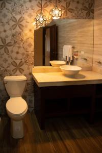 a bathroom with two sinks and a toilet at Evergreen Lodge in Tortuguero
