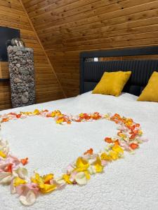 a bed with a heart made out of flowers on it at ECO PARK ASPAN in Almaty