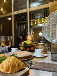 a table topped with bread and a glass of wine at ECO PARK ASPAN in Almaty