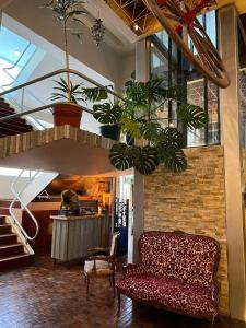 a living room with a couch and some plants at Atlantida Hotel in Río Grande