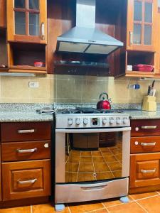 a kitchen with a stove with a tea kettle on it at Casa Mágica in Flores
