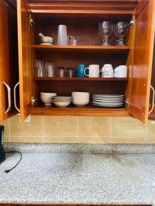 a cabinet filled with plates and cups and dishes at Casa Mágica in Flores