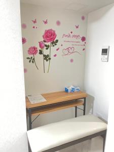 a room with a table and flowers on the wall at 303 Oshiage sta 3mins walk! Wi-Fi & Elevator 4pax in Tokyo