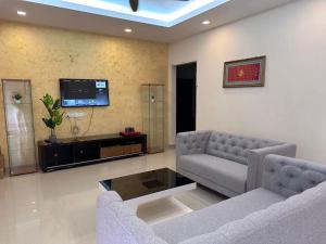 a living room with two couches and a tv at Desa Tebrau 1 Near IKEA Toppen PeiKin Long Sing HeLiXuan Restaurant in Johor Bahru
