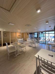 a dining room with tables and chairs and windows at Atlantida Hotel in Río Grande