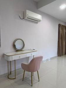 a dressing table with a mirror and a pink chair at 2 JB Adda Daya Setia Eco Austin 24paxs Pool Table in Johor Bahru