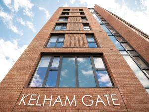 a tall brick building with the words kleinham gate at Kelham Gate Central Apartments Near Peaks Crucible Utilita Arena in Sheffield