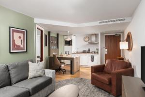 a living room with a couch and a kitchen at Staybridge Suites Newcastle, an IHG Hotel in Newcastle upon Tyne