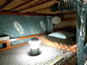 a bedroom with a bunk bed with a horse on the wall at Amami Guest House showa-so in Setouchi
