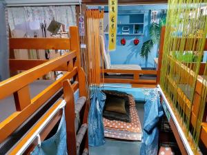 ein Spielzeugzimmer mit einem Bett und einem Stuhl in der Unterkunft Amami Guest House showa-so in Setouchi
