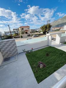 a backyard with a yard of green grass at BlueLine apartment 3 in Loutraki